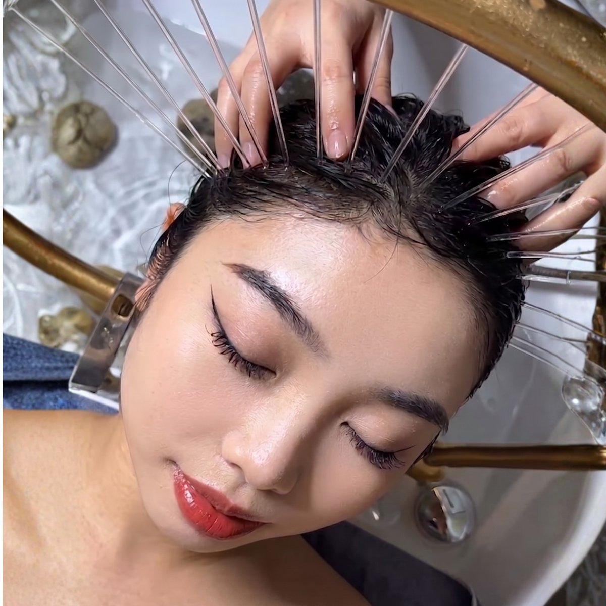 A guest receives a scalp acupressure treatment during Pamperloft's signature Meridian Head Spa
